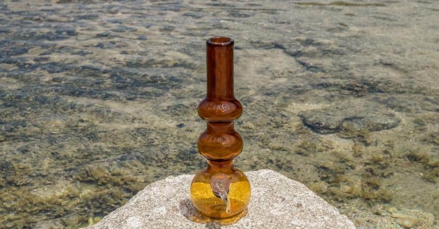 bong on a stone near the ocean