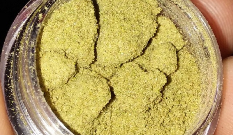 Kief in container in the hand